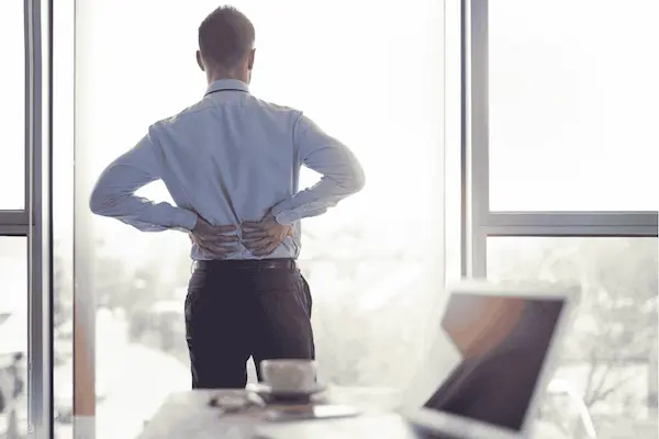 Person experiencing sciatica and leg pain